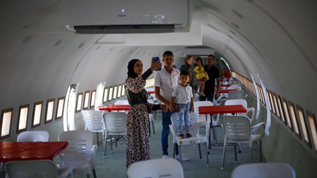 Palestinians visit the interior of a Boeing 707 after it was converted to a cafe restaurant.