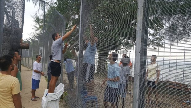Manus Island refugees are securing damaged perimeter fences at the processing centre against possible attacks.
