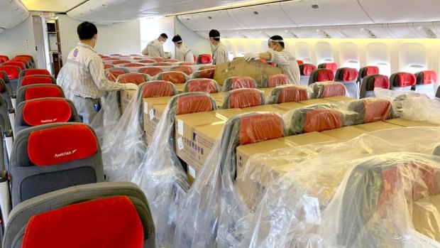 An Austrian Airlines passenger cabin filled with cargo.