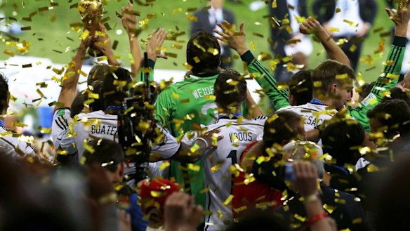 Germany's players hold up the World Cup trophy.