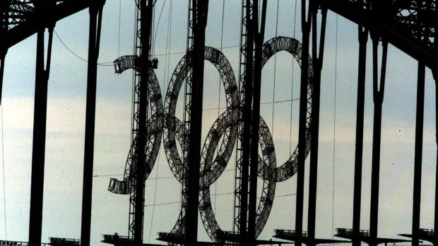 The Olympic rings being removed from the Harbour Bridge. 