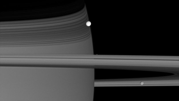 Brilliant Enceladus sits on Saturn's edge.