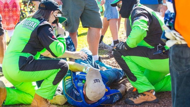 Medical officers tend to a spectator after tyre debris hit the crowd in Newcastle. 
