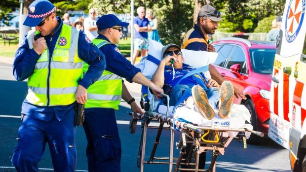 Medical officers tend to a spectator after tyre debris hit the crowd in Newcastle. 