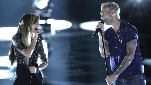 Maroon 5 frontman Adam Levine performs with Christina Grimmie on <i>The Voice</i> in 2014.