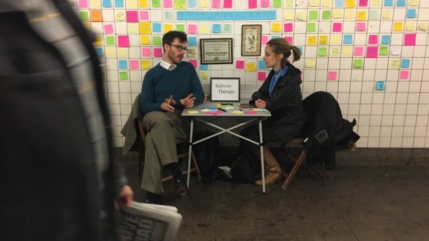 Sam Lane sits with Matthew 'Levee' Chavez, the creator of Subway Therapy, at 14th Street Station, Manhattan.