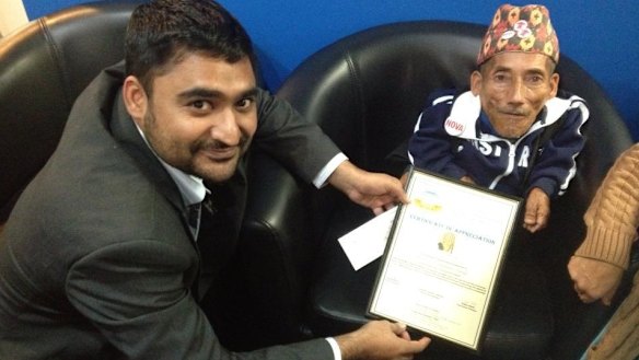 Amarjhit Khela presents a certificate of appreciation to Chandra Bahadur Dangi.