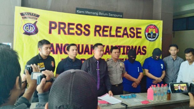 Two suspects paraded before the media after the capture of the alleged producer of bootleg liquor in Yogyakarta.
