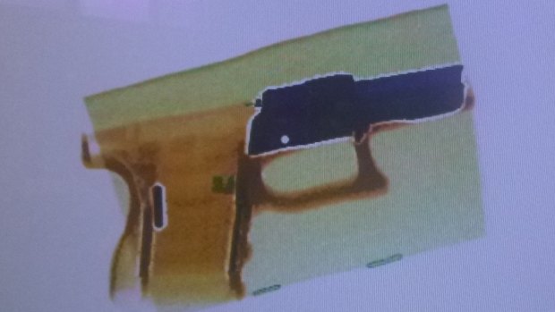 AN X-ray image of a gun part.