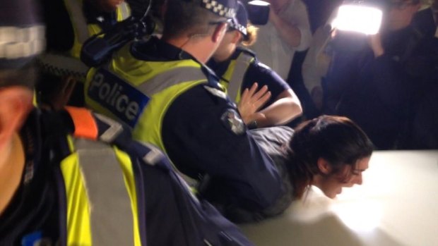 Police arrest a protester.