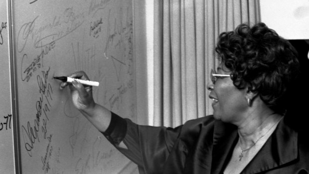 Ella Fitzgerald signs her name at the Opera House.