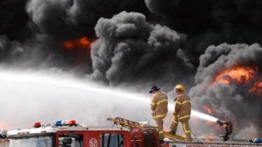 Firefighters fight to control the tyre fire in Broadmeadows, Melbourne on Monday.