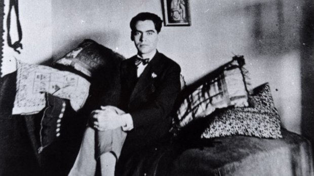 Federico Garcia Lorca at home in Granada in 1925, beneath one of several paintings Salvador Dali gave him in the mid-1920s. 