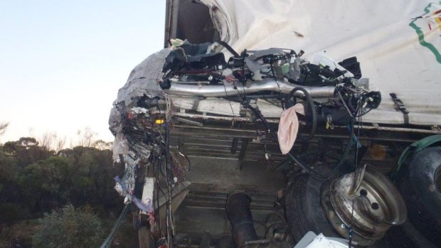 Photos of the crash show a steering wheel wedged within the road train wreckage. 
