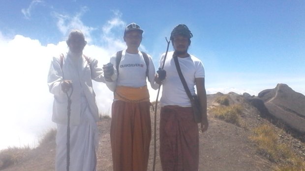 Three of the four men who climbed to the summit of Mount Agung on Friday. Jero Mangku Ada, behind the camera, said he was asked by the gods to make an offering. 