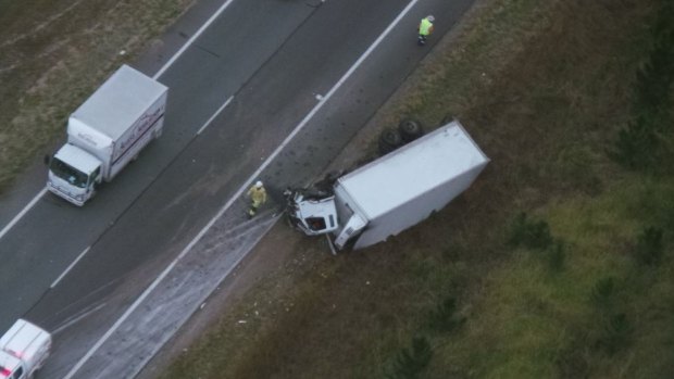 A truck crossed the Bruce Highway north of Brisbane before colliding with a ute in the southbound lanes.