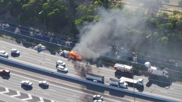 A garbage truck burns after catching fire on the Gateway Motorway.