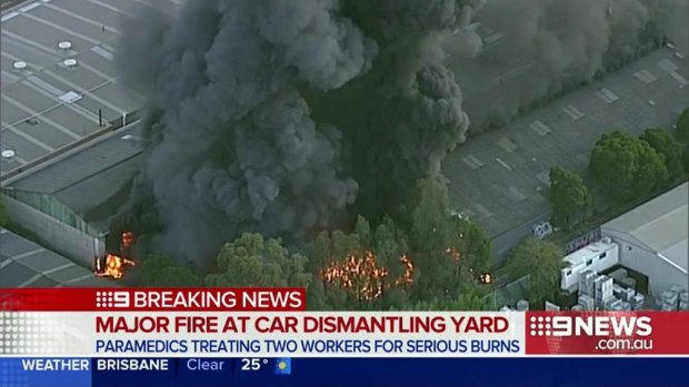 A huge plume of smoke rises from the blaze at the car wrecking yard in Revesby in Sydney's south-west.