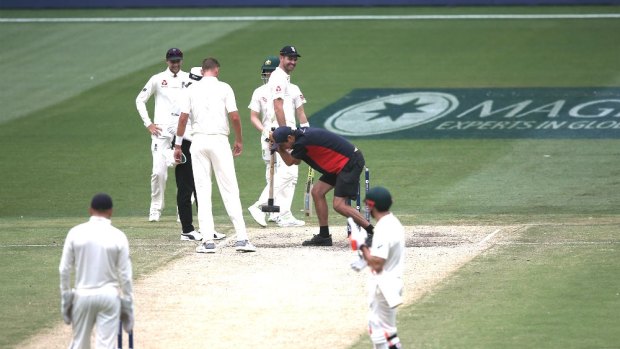 Running repairs: The MCG pitch was under scrutiny from the outset.