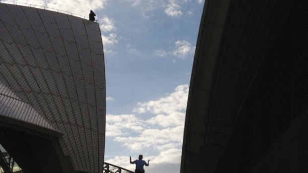 High drama on the House: Police escorted a man who climbed onto the Opera House back to ground level on Sunday.