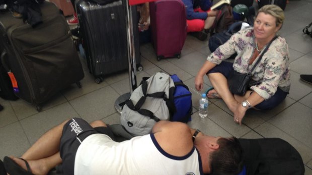Confusion and fatigue: passengers stranded at Sydney Airport. 