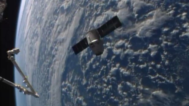 The SpaceX Dragon resupply capsule approaching the International Space Station.