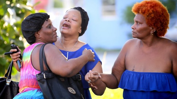 Bennae Robinson (centre), aunt of shooting victim Kevin Richardson, reacts to the death of her nephew who was gunned down outside an apartment complex in in Miami, Florida, on Tuesday. 
