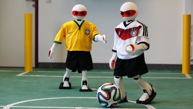 Humanoid robots dressed in the colours of Germany and Brazil at the Institute for Computer Science at the University of Bonn ahead of the 2014 RoboCup.