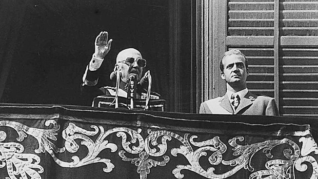 Spanish dictator General Francisco Franco, left, gestures during a speech on the balcony of the Oriente Palace in Madrid. Listening on is Juan Carlos de Borbon, who was crowned king after Franco's death. Franco seized on the referendum to further his own ends.