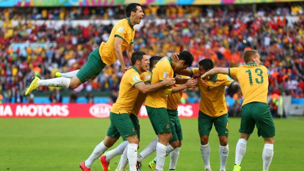 Growing confidence ...  captain Mile Jedinak of Australia (centre) celebrates scoring his team's second goal against the Netherlands with his teammates.