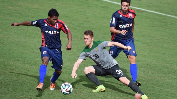 Oliver Bozanic (centre) controls the ball during the Socceroos' practice match against Brazilian State League side Parana Clube in Vitoria on Monday. 
