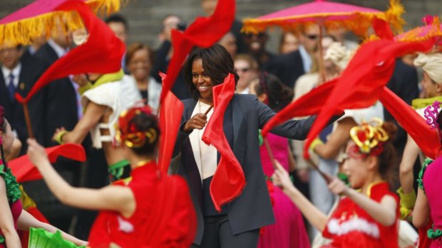 Stepping out: US first lady Michelle Obama dances with folk performers as she visits the Xi'an city wall.