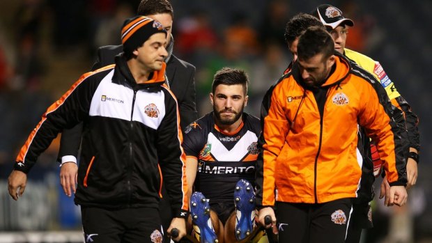 Wests Tigers fullback James Tedesco is stretchered off Campbelltown Stadium after injuring his knee against Canberra.