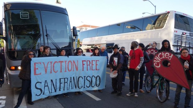 An anti-eviction protest surrounds an Apple shuttle bus in San Francisco.