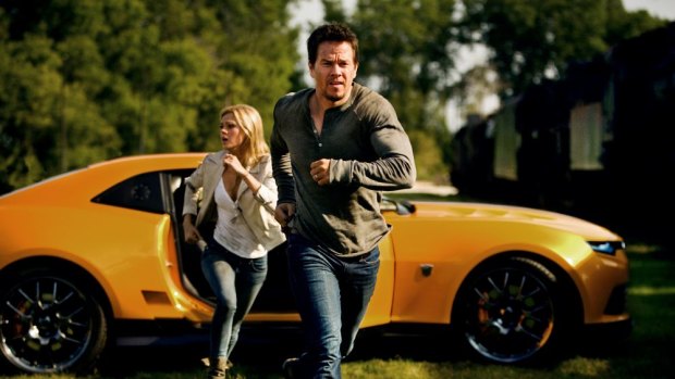 On the run: Mark Wahlberg and Nicola Peltz in a scene from <i>Transformers: Age of Extinction</i>.