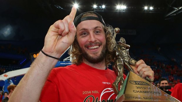 Wildcats player Jesse Wagstaff with the NBL trophy.