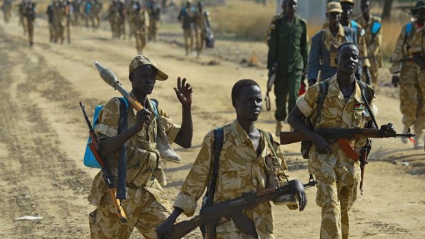 Sudan People's Liberation Army (SPLA) government soldiers walk along a road in Mathiang near Bor on January 31, 2014.