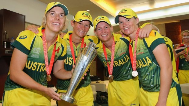 Jess Cameron (far right) celebrates with  Elyse Villani, Julie Hunter and Meg Lanning  with the Women's World Twenty20 trophy in 2014.