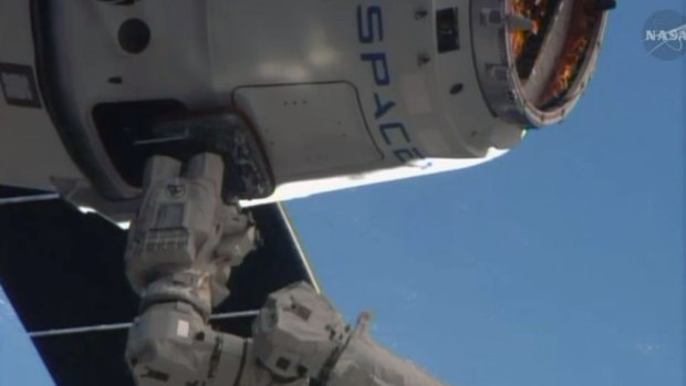 The SpaceX Dragon resupply capsule captured by the Canadarm2 from the International Space Station.