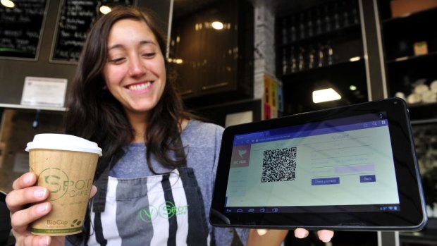 V Spot Cafe assistant manager Monica Furastec Danilevicz shows how the cafe accepts bitcoin payment.