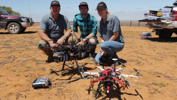 Drone owner Warren Abrams, left, with unidentified staff members.