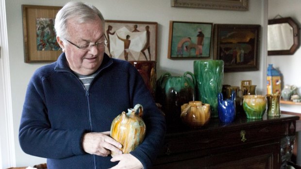 Kevin Power with part of his Tasmanian pottery collection at his Wollstonecraft home in Sydney.
