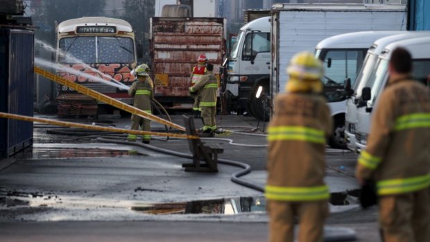 Firefighters at the site in Alexandria.