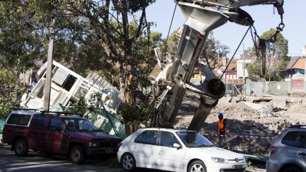 A toppled crane narrowly avoided cars in Newtown on Friday. 