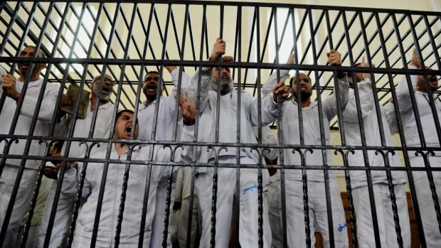 Supporters of Egypt's ousted President Mohmmed Morsi charged with violence during a trial in court in Alexandria in 2014. 