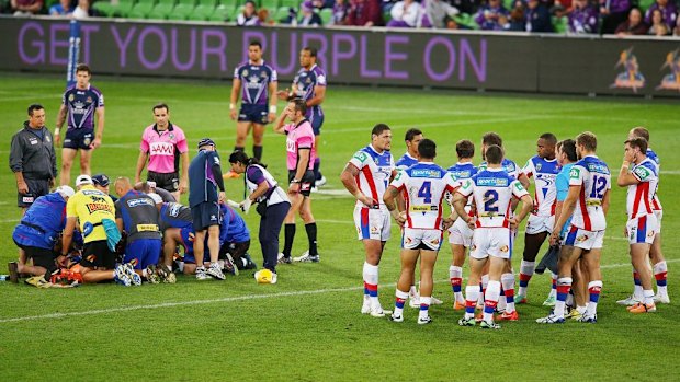 Broken: Trainers treat Alex McKinnon following his injury.