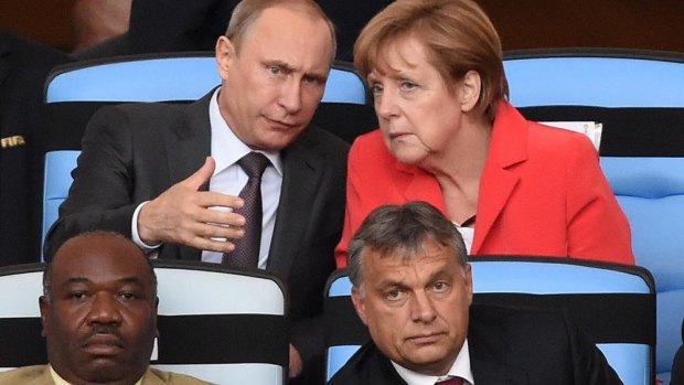 VVIPs: Russian President Vladimir Putin chats to German Chancellor Angela Merkel, while Gabon President Ali Bongo Ondimba Hungarian Prime Minister Viktor Orban watch intently.