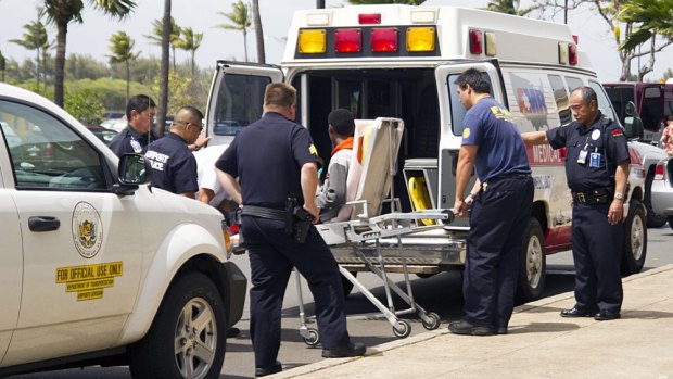 The 16-year-old who stowed away on a California to Hawaii flight, seen here on a stretcher, is loaded into an ambulance at Kahului Airport on the Hawaiian island of Maui on Sunday.