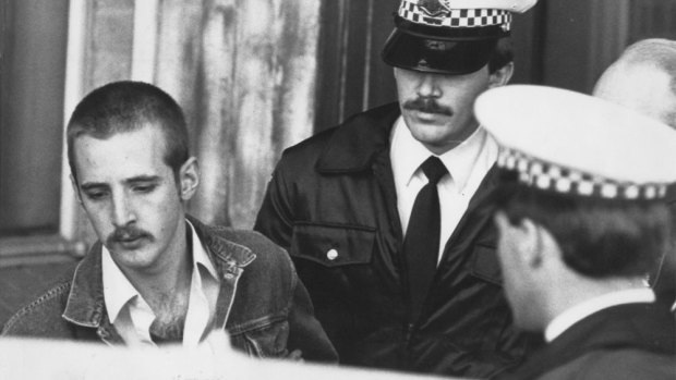 Julian Knight, left, being taken away by police after the Hoddle Street shooting. 