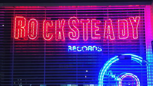 A neon sign beckons music lovers to Rocksteady Records in Melbourne.